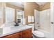 Bathroom featuring a vanity with ample counter space, shower-tub, and linen storage at 3210 Avondale Pkwy, Powder Springs, GA 30127