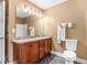 Bathroom with double sinks, wood cabinetry, granite counters, and a tiled floor at 3210 Avondale Pkwy, Powder Springs, GA 30127