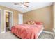 Bedroom with an adjoining bathroom featuring neutral paint and a ceiling fan at 3210 Avondale Pkwy, Powder Springs, GA 30127