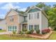 Lovely two-story home featuring brick and vinyl siding, complemented by lush landscaping and a driveway at 3210 Avondale Pkwy, Powder Springs, GA 30127