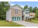 Beautiful two-story home showcasing brick and vinyl siding, a spacious yard, and an attached garage at 3210 Avondale Pkwy, Powder Springs, GA 30127