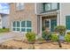 Inviting two-story home with brick and vinyl siding, featuring a charming front entrance and landscaping at 3210 Avondale Pkwy, Powder Springs, GA 30127