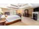 Spacious main bedroom with tray ceiling, fireplace, and sitting area at 3210 Avondale Pkwy, Powder Springs, GA 30127
