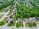 Aerial view of home with a manicured lawn and mature trees at 3320 Goldmist Dr, Buford, GA 30519