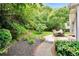 Serene backyard with lush greenery, mature trees, and an outdoor dining area at 3320 Goldmist Dr, Buford, GA 30519