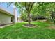 Backyard features a well-maintained lawn and mature trees and landscaping at 3320 Goldmist Dr, Buford, GA 30519