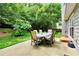 Outdoor patio featuring a dining table with seating for six amid mature trees at 3320 Goldmist Dr, Buford, GA 30519