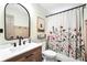 Stylish bathroom featuring a floral shower curtain, modern fixtures, and wood-look vanity at 3320 Goldmist Dr, Buford, GA 30519