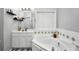 Well-lit bathroom featuring a soaking tub, vanity with countertop, and tiled walls at 3320 Goldmist Dr, Buford, GA 30519