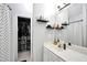 Bright bathroom with a walk in closet, decorative shelves, shower and a white vanity at 3320 Goldmist Dr, Buford, GA 30519
