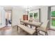 Dining room with wood floors, dining table with four chairs and bench and lots of natural light at 3320 Goldmist Dr, Buford, GA 30519