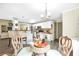 Open concept dining room features decorative chairs, a glass table and connects to the kitchen at 3320 Goldmist Dr, Buford, GA 30519