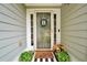Inviting front entry with decorative door decor and planters on either side at 3320 Goldmist Dr, Buford, GA 30519