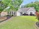 Charming brick home with well-manicured lawn, landscaping, and curb appeal at 3320 Goldmist Dr, Buford, GA 30519