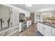 Bright kitchen features stainless appliances, white cabinetry, and tile backsplash at 3320 Goldmist Dr, Buford, GA 30519