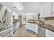 Bright kitchen features stainless appliances, white cabinetry, and tile backsplash at 3320 Goldmist Dr, Buford, GA 30519