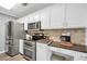Bright kitchen with stainless steel appliances, tile backsplash, and white cabinetry at 3320 Goldmist Dr, Buford, GA 30519