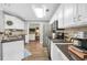 Bright kitchen with stainless steel appliances, tile backsplash and white cabinetry at 3320 Goldmist Dr, Buford, GA 30519