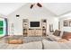 Bright living room with vaulted ceilings, ceiling fan, and a decorative entertainment center at 3320 Goldmist Dr, Buford, GA 30519