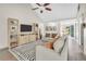 Bright living room with vaulted ceilings, ceiling fan, and a decorative entertainment center at 3320 Goldmist Dr, Buford, GA 30519