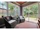 Cozy sun room featuring wicker chairs, patterned rug, and sliding glass doors to the backyard at 3320 Goldmist Dr, Buford, GA 30519