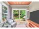 Bright sun room with patio access, copper ceiling and comfortable seating area at 3320 Goldmist Dr, Buford, GA 30519