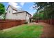 Spacious backyard with wooden fence, elevated deck, stairs, and a patio area, perfect for outdoor living at 3920 Baverton Dr, Suwanee, GA 30024