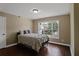 Comfortable bedroom with natural light from a large window and hardwood floors at 3920 Baverton Dr, Suwanee, GA 30024