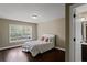 Bright bedroom with hardwood floors and natural light from a window at 3920 Baverton Dr, Suwanee, GA 30024