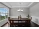 Bright dining room with hardwood floors, wainscoting, and a large window at 3920 Baverton Dr, Suwanee, GA 30024