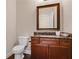 Stylish half bathroom with vanity, framed mirror, and marble countertop at 3920 Baverton Dr, Suwanee, GA 30024