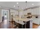 Modern kitchen featuring a center island with bar seating, stainless appliances, and hardwood floors at 3920 Baverton Dr, Suwanee, GA 30024