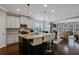 Open kitchen featuring granite countertops, white cabinets, and seating at the island at 3920 Baverton Dr, Suwanee, GA 30024