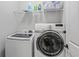 Well-equipped laundry room with modern washer and dryer and storage shelving above at 3920 Baverton Dr, Suwanee, GA 30024