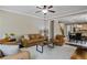 Inviting living room with hardwood floors, ceiling fan, neutral walls, and comfortable leather furniture at 3920 Baverton Dr, Suwanee, GA 30024