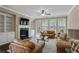 Cozy living room featuring built-in cabinets, fireplace, and large windows overlooking the backyard at 3920 Baverton Dr, Suwanee, GA 30024