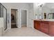 Main bathroom with dual vanities and doorways to the shower, toilet, and closet at 3920 Baverton Dr, Suwanee, GA 30024