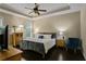 Tranquil main bedroom boasts a tray ceiling, wood floors, and a view of the outdoors at 3920 Baverton Dr, Suwanee, GA 30024