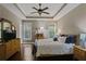 Spacious main bedroom with ceiling fan, hardwood floors, windows, and furniture at 3920 Baverton Dr, Suwanee, GA 30024
