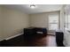Functional office space with dark wood floors, L-shaped desk, and lots of natural light at 3920 Baverton Dr, Suwanee, GA 30024