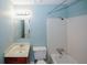 Bathroom with sink, toilet, mirror, vanity, and shower/tub with white tile at 5461 Park S Pl, Atlanta, GA 30349