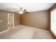 Bedroom featuring a ceiling fan, access to a bathroom and a window at 5461 Park S Pl, Atlanta, GA 30349