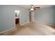 Bedroom with ceiling fan, carpet flooring, neutral colored walls and attached bath at 5461 Park S Pl, Atlanta, GA 30349