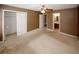 Bedroom includes closet and bathroom doors, and features a ceiling fan at 5461 Park S Pl, Atlanta, GA 30349