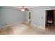 Bedroom with ceiling fan, carpet flooring, neutral colored walls and attached bath at 5461 Park S Pl, Atlanta, GA 30349