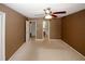 Bedroom includes closet and bathroom doors, and features a ceiling fan at 5461 Park S Pl, Atlanta, GA 30349