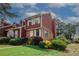 Charming home featuring brick accents, manicured bushes, and a lush green lawn at 5461 Park S Pl, Atlanta, GA 30349