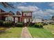 Inviting two-story home with red siding, white trim, and well-maintained landscaping at 5461 Park S Pl, Atlanta, GA 30349