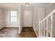 Bright entryway with wood floors, white trim, and staircase leading to the upper level at 5461 Park S Pl, Atlanta, GA 30349