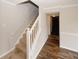 Hallway with stairs showcasing neutral paint, hardwood floors and white trim at 5461 Park S Pl, Atlanta, GA 30349